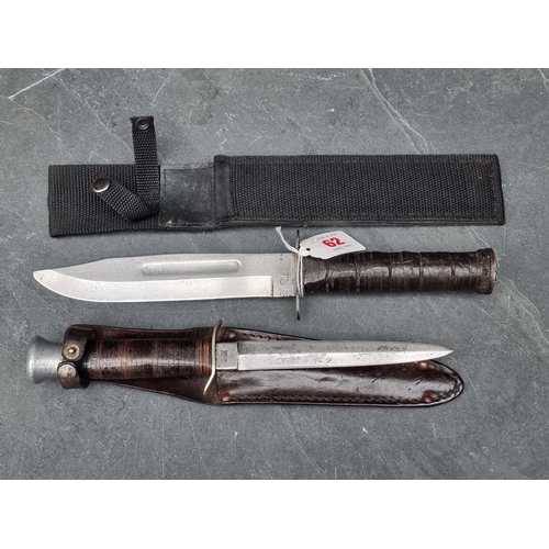 62 - A combat knife, stamped 'US  Japan', with 17.5cm blade, in later scabbard; together with a Milbro 'K... 