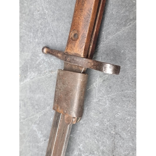 67 - An Italian M1891 Carcano bayonet and scabbard, the 29cm blade marked 'Terni' to the ricasso and stam... 