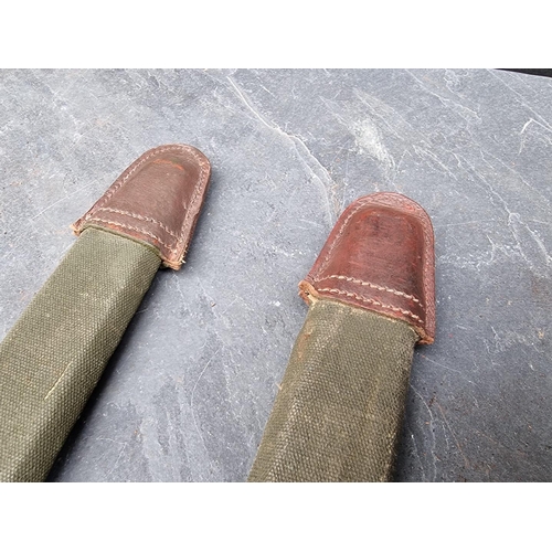 85 - Two canvas and leather covered bayonet scabbards, M1909?, each approximately 45cm long.... 