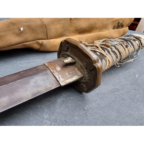 92 - A Japanese katana, having 66.5cm blade, in canvas carrying case.