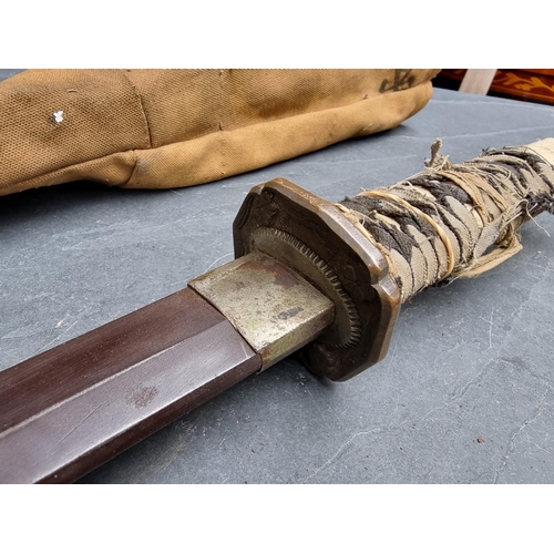 92 - A Japanese katana, having 66.5cm blade, in canvas carrying case.