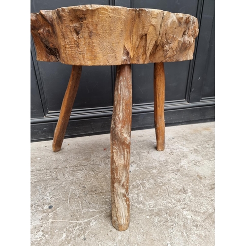 1020 - An old Brutalist tripod tree truck table, 67cm high x 67cm wide, (worm to legs).