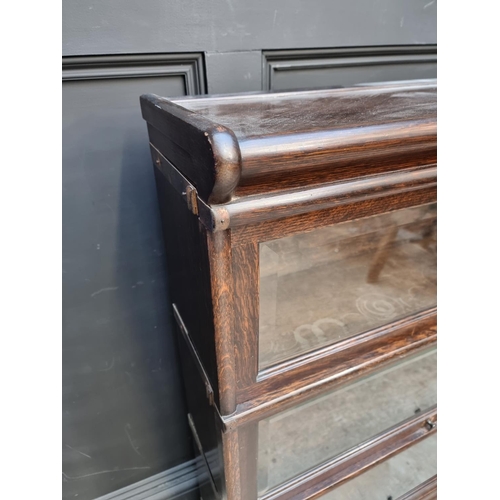 1027 - An early 20th century Globe Wernicke oak three tier sectional bookcase, with bevelled glass, 86.5cm ... 