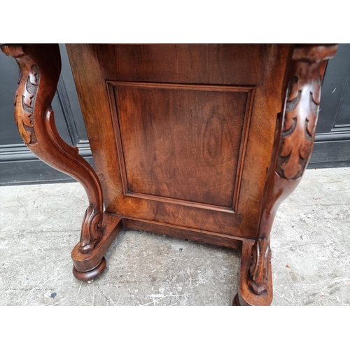 1028 - A Victorian walnut Davenport, 54.5cm wide.