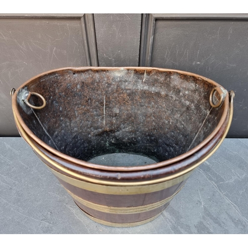 1030 - A George III mahogany and brass bound peat bucket, 34cm wide. 