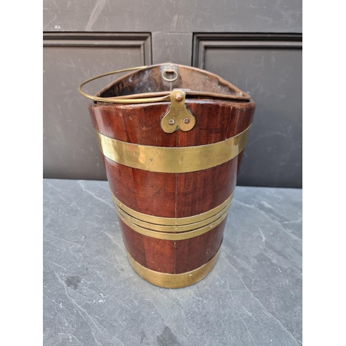 1030 - A George III mahogany and brass bound peat bucket, 34cm wide. 