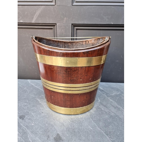 1030 - A George III mahogany and brass bound peat bucket, 34cm wide. 