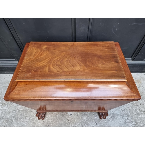 1032 - A George IV mahogany sarcophagus cellarette, on paw feet, with partially fitted interior, 69cm wide,... 