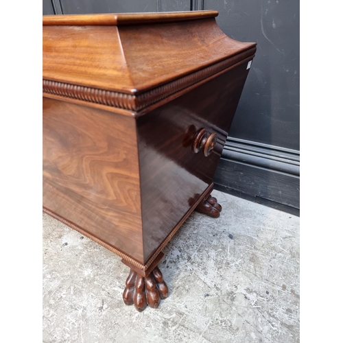 1032 - A George IV mahogany sarcophagus cellarette, on paw feet, with partially fitted interior, 69cm wide,... 