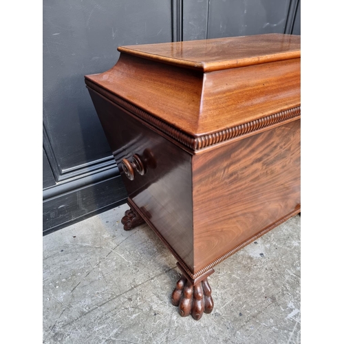 1032 - A George IV mahogany sarcophagus cellarette, on paw feet, with partially fitted interior, 69cm wide,... 