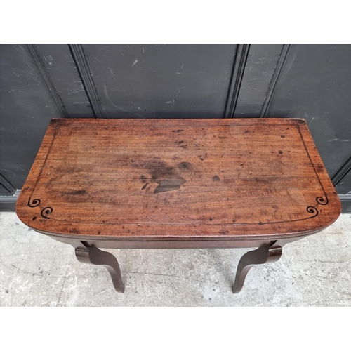 1035 - A Regency mahogany and ebony strung card table, with double gateleg action, 86.5cm wide.... 