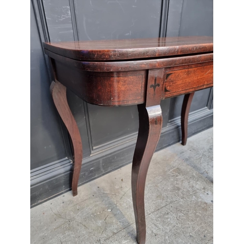 1035 - A Regency mahogany and ebony strung card table, with double gateleg action, 86.5cm wide.... 