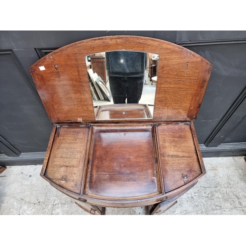 1041 - A mahogany bowfront kneehole dressing table, with hinged top, 83.5cm wide. 