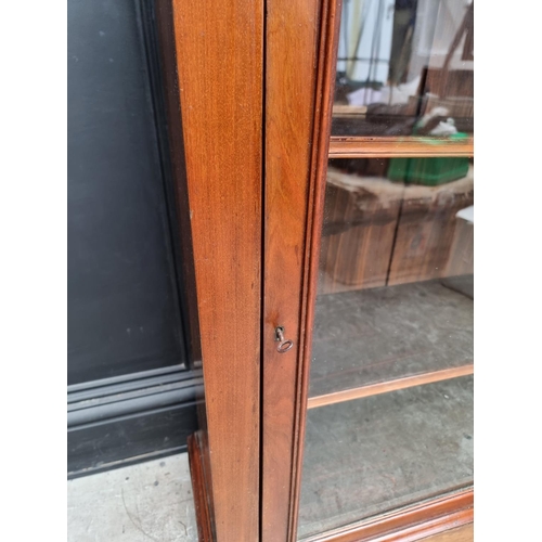 1049 - An early 20th century mahogany pier cabinet, 80.5cm wide. 