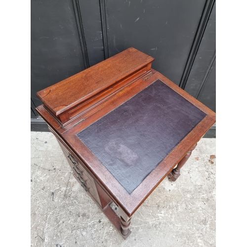 1050 - A late Victorian mahogany Davenport, 55.5cm wide. 