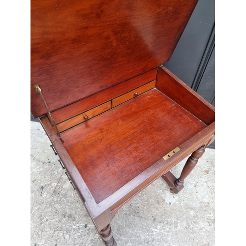 1050 - A late Victorian mahogany Davenport, 55.5cm wide. 