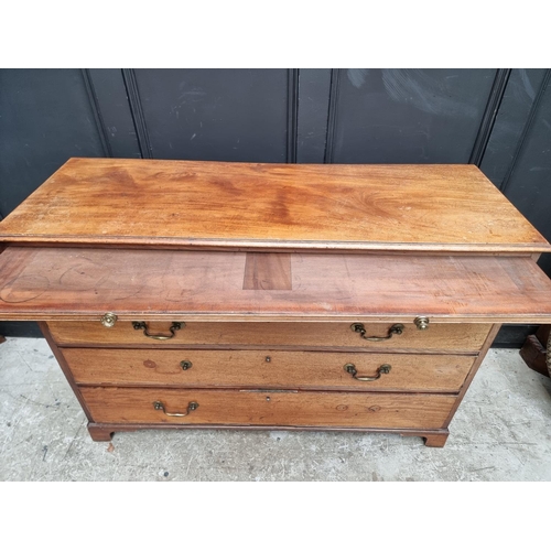 1052 - A George III mahogany chest of drawers, with brushing slide, 125cm wide. 