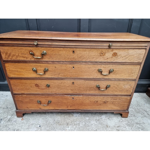 1052 - A George III mahogany chest of drawers, with brushing slide, 125cm wide. 