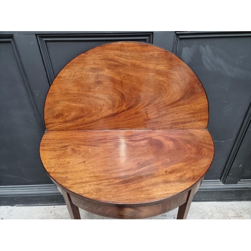 1056 - A George III mahogany and line inlaid demi-lune tea table, with double gateleg action, 95cm wide.... 