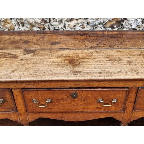 1058 - A George III oak pot board dresser base, 180cm wide. 