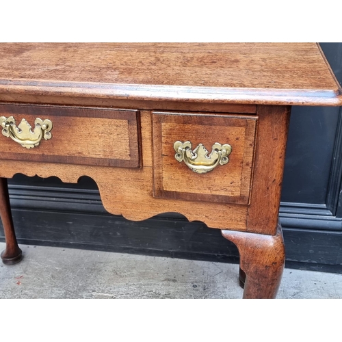 1060 - A George II mahogany and walnut crossbanded lowboy, 88cm wide.