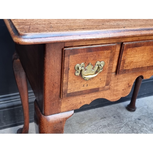 1060 - A George II mahogany and walnut crossbanded lowboy, 88cm wide.