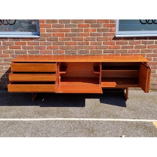 1100 - A mid-century teak sideboard, by White & Newton, labelled, 216.5cm wide.