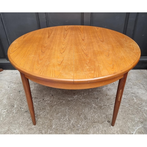 1113 - A mid-century G-Plan teak extending dining table and six chairs, the table 168.5cm extended.... 