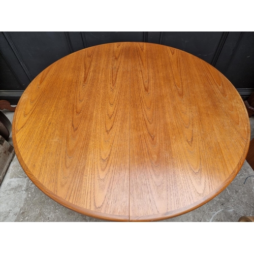 1113 - A mid-century G-Plan teak extending dining table and six chairs, the table 168.5cm extended.... 