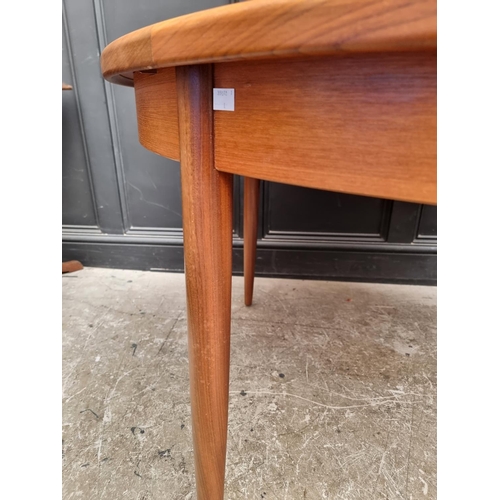 1113 - A mid-century G-Plan teak extending dining table and six chairs, the table 168.5cm extended.... 