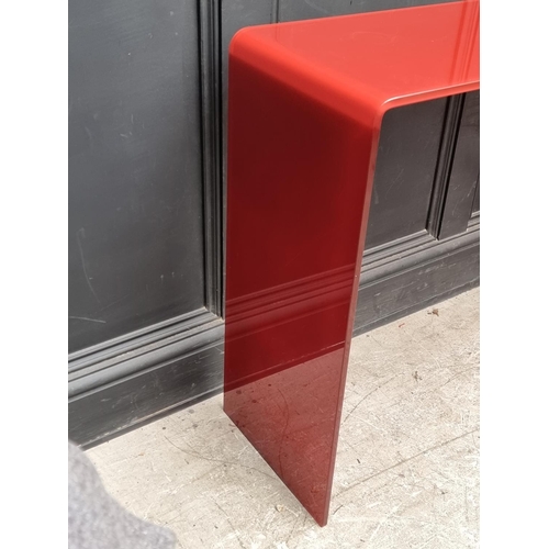 1121 - An Italian red glass console table, 101cm wide.