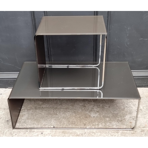 1122 - Two Italian smoked glass and chrome occasional tables, 109cm wide. (2)