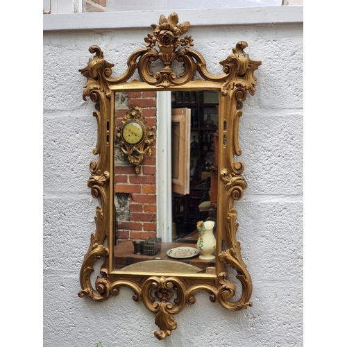 1124 - An 18th century carved giltwood framed wall mirror, 69 x 49cm.