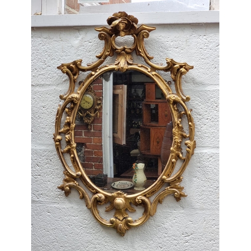 1128 - An 18th century carved giltwood frame wall mirror, 83 x 52cm.