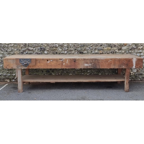 1136 - A very large vintage pine woodworking bench, 337cm long.