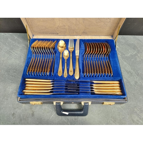 1143 - A case of gilt plated cutlery, for eleven, by Bestecke, Solingen.