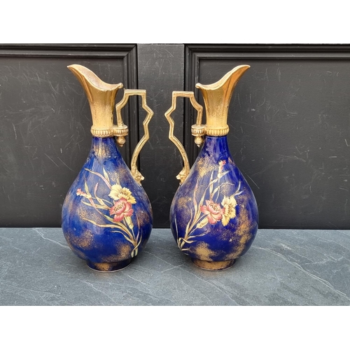 1180 - A pair of antique pottery ewers, 37cm high.