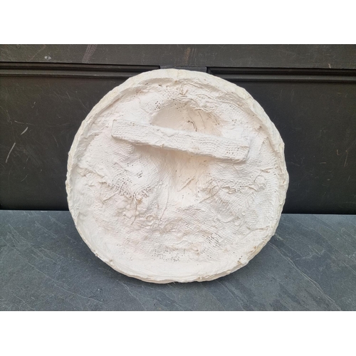 1182 - A plaster relief plaque of a girl with a bird, 44cm diameter, (chips).