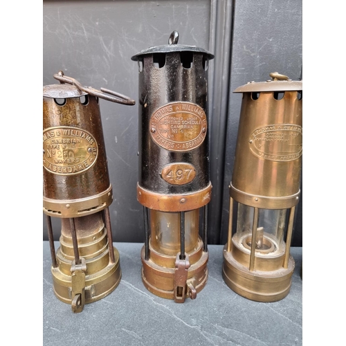 1185 - Four vintage miner's lamps; and another later example. (5)