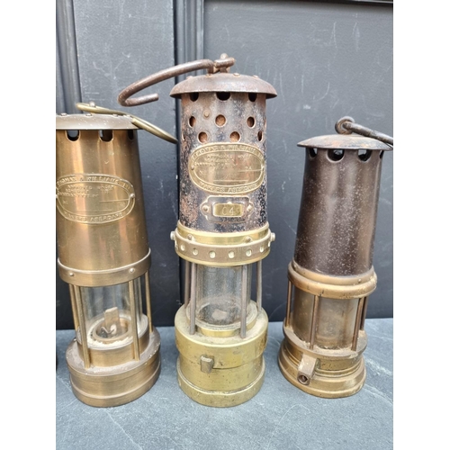 1185 - Four vintage miner's lamps; and another later example. (5)