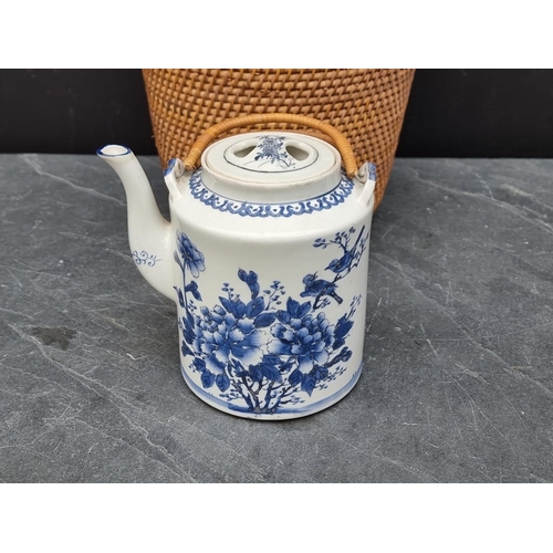 1206 - A Chinese blue & white teapot and cover, in wicker case.