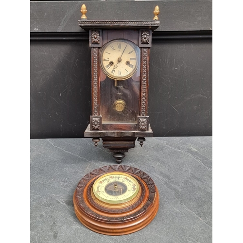 1207 - A small antique Continental musical wall clock, 42cm high; together with a carved walnut aneroid bar... 