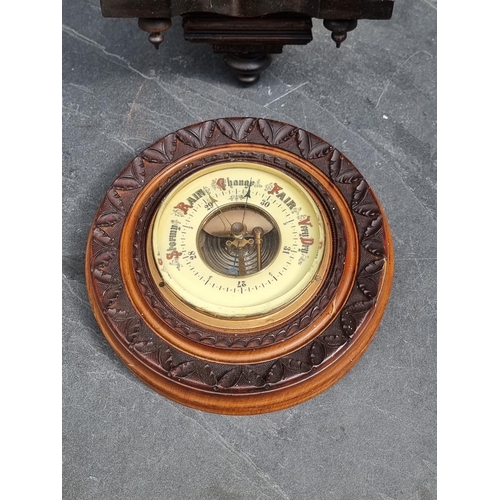 1207 - A small antique Continental musical wall clock, 42cm high; together with a carved walnut aneroid bar... 