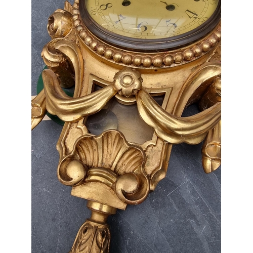 1236 - A giltwood wall clock, with painted dial, 54cm high, with pendulum.