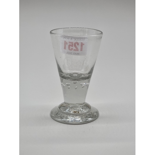 1251 - An 18th century Continental drinking glass, with engraved decoration, 10.5cm high.