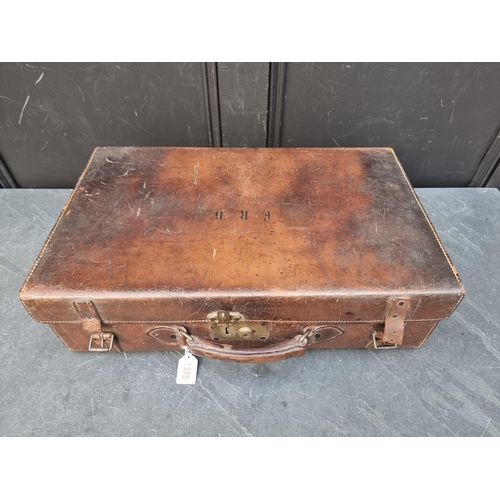 1275 - A vintage tan leather toilet case, lacking fittings.