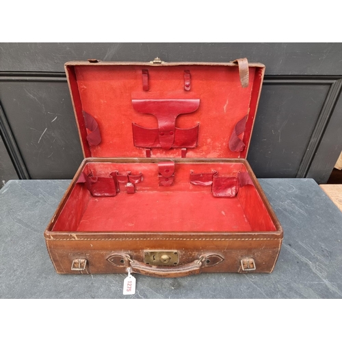 1275 - A vintage tan leather toilet case, lacking fittings.