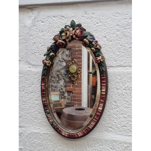 1285 - A vintage Barbola framed oval wall mirror, 41 x 24.5cm.