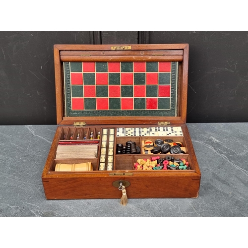 1304 - A Victorian mahogany games compendium, with fitted interior, 33.5cm wide.