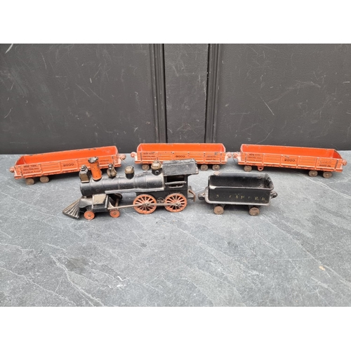 1317 - An antique cast iron 4-4-0 locomotive and four tenders.  ... 